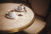 Two coffee cups on a table.